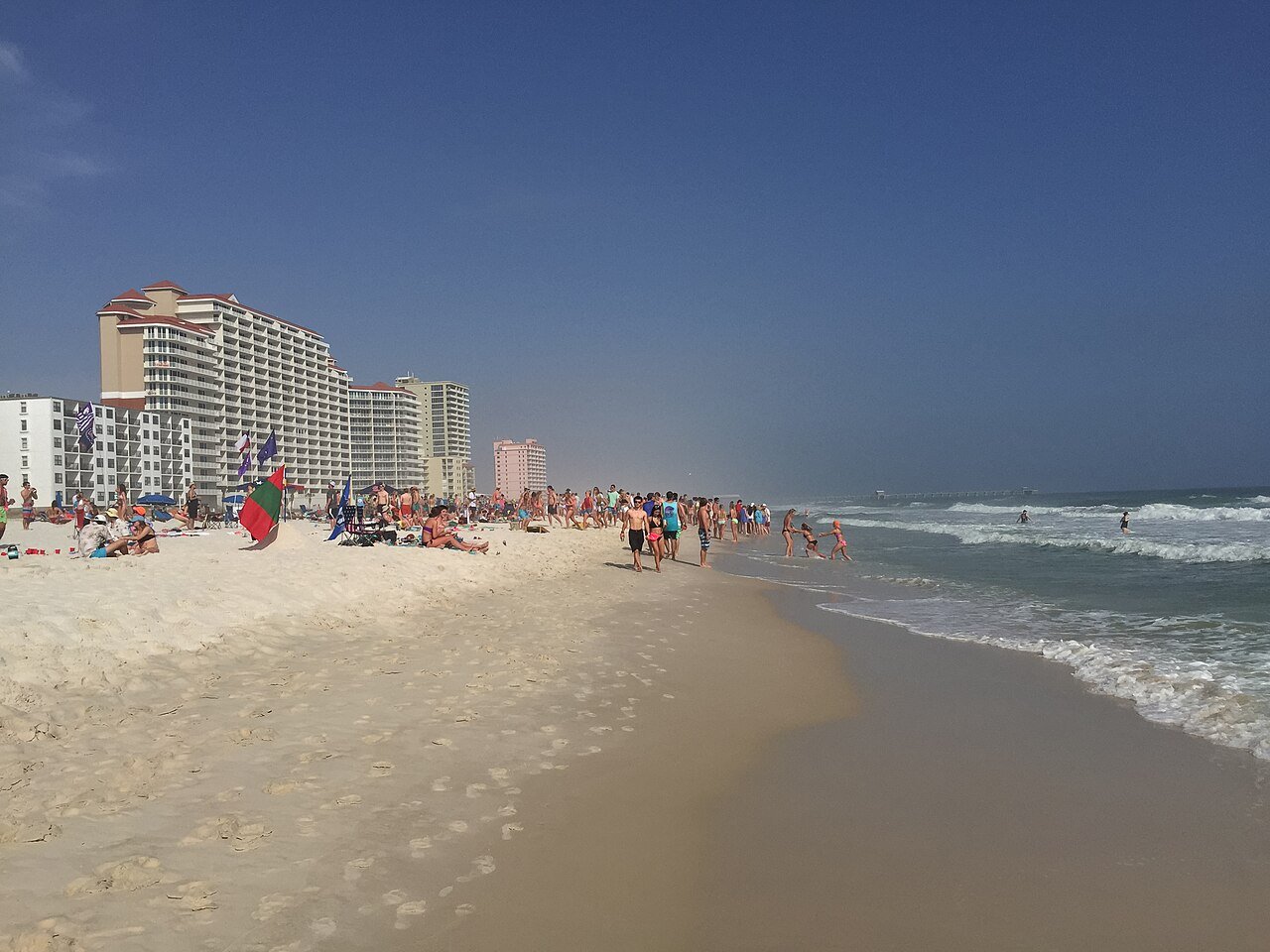 Wide sandy beach and blue Gulf water at Gulf Shores, Alabama.