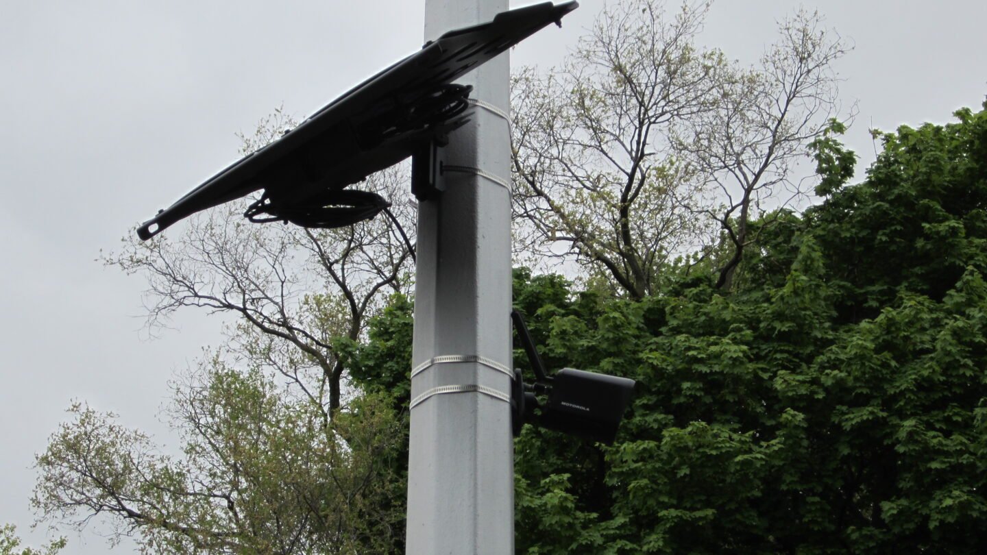 Automated license plate reader camera mounted on a roadside pole