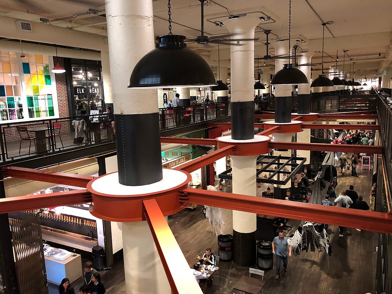 White columns, black pendant lights, and diners inside Ponce City Market’s Central Food Hall.